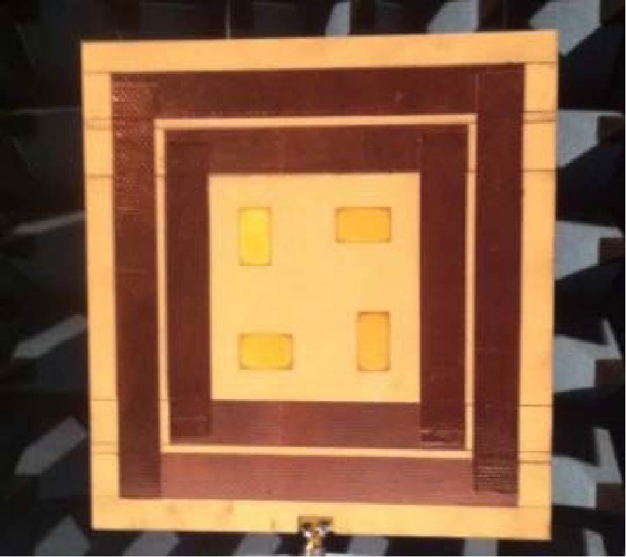 ON THE USE OF METAL GRATINGS TO REDUCE DIFFRACTION FROM A FINITE GROUND PLANE IN CIRCULARLY-POLARIZED MICROSTRIP ARRAYS